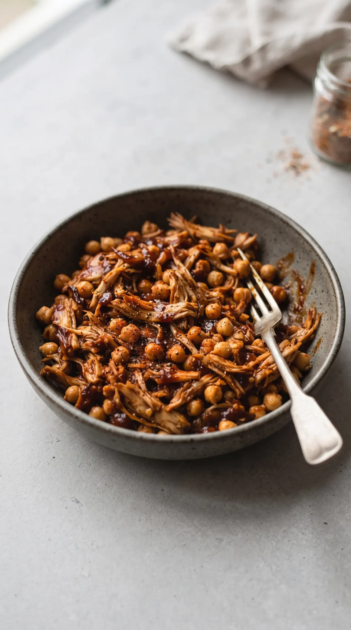 Shredded BBQ jackfruit and chickpea filling in a bowl with barbecue seasoning