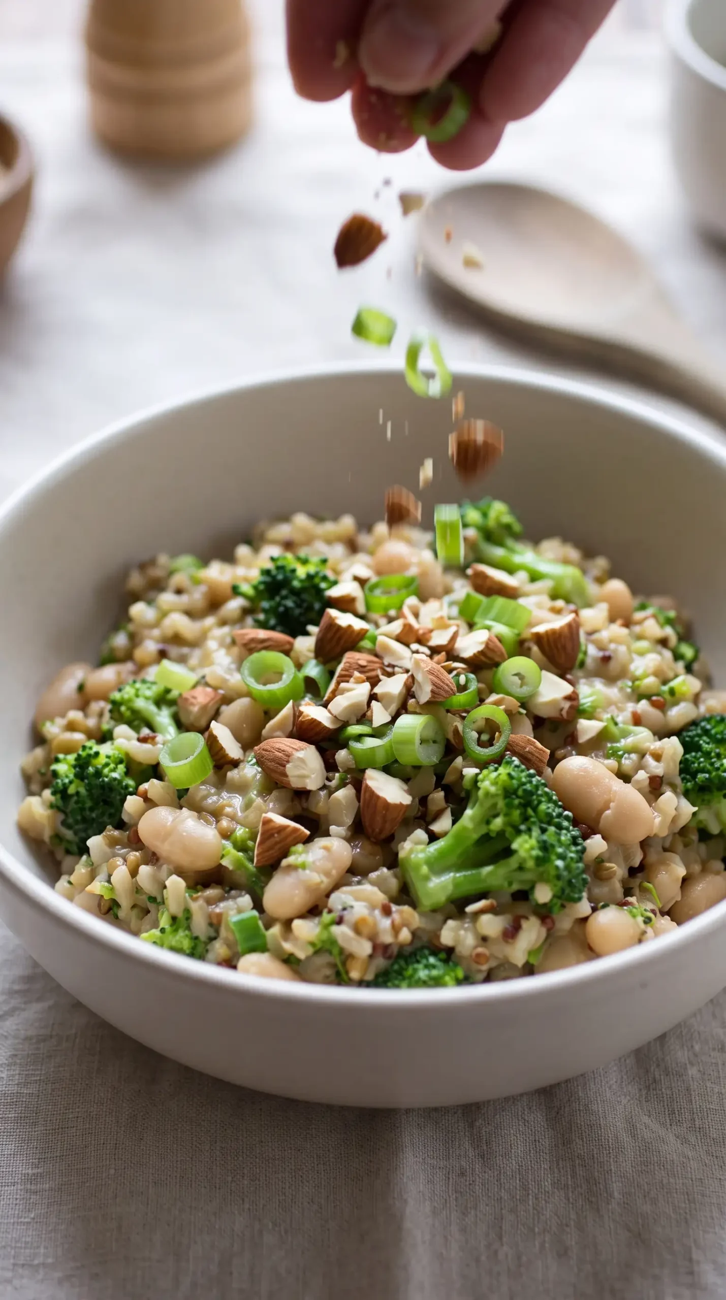 Broccoli cheese rice topped with crushed almonds and sliced green onions