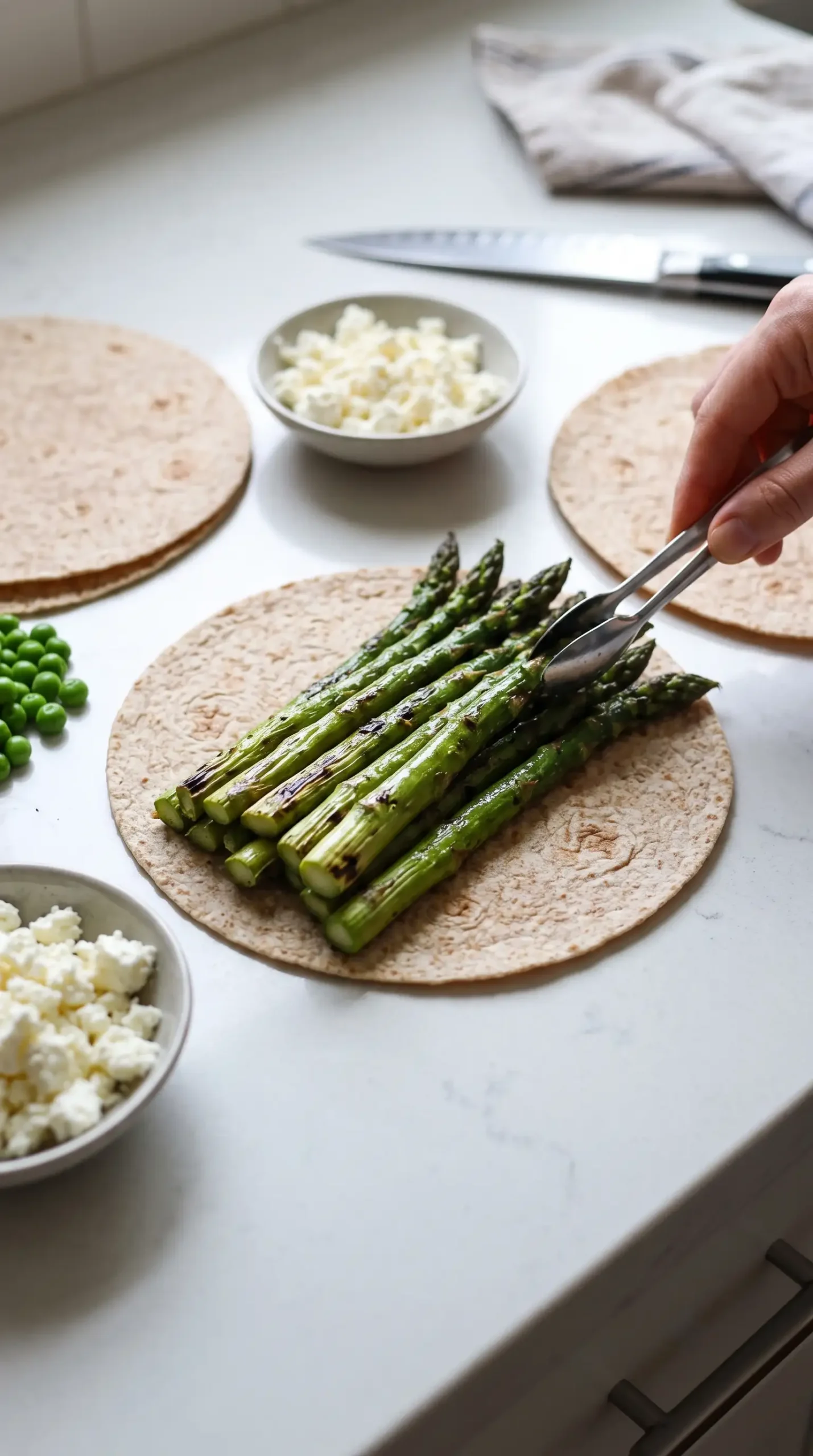 Grilled asparagus arranged as a vegetable layer for an asparagus quesadilla