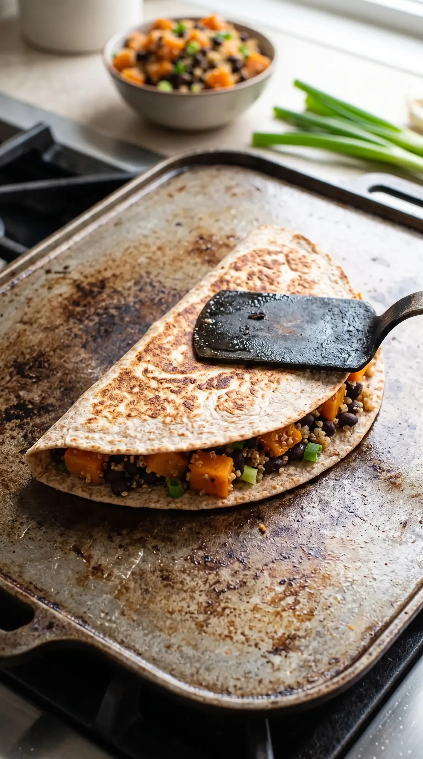Whole wheat butternut squash black bean wrap grilling on a panini press