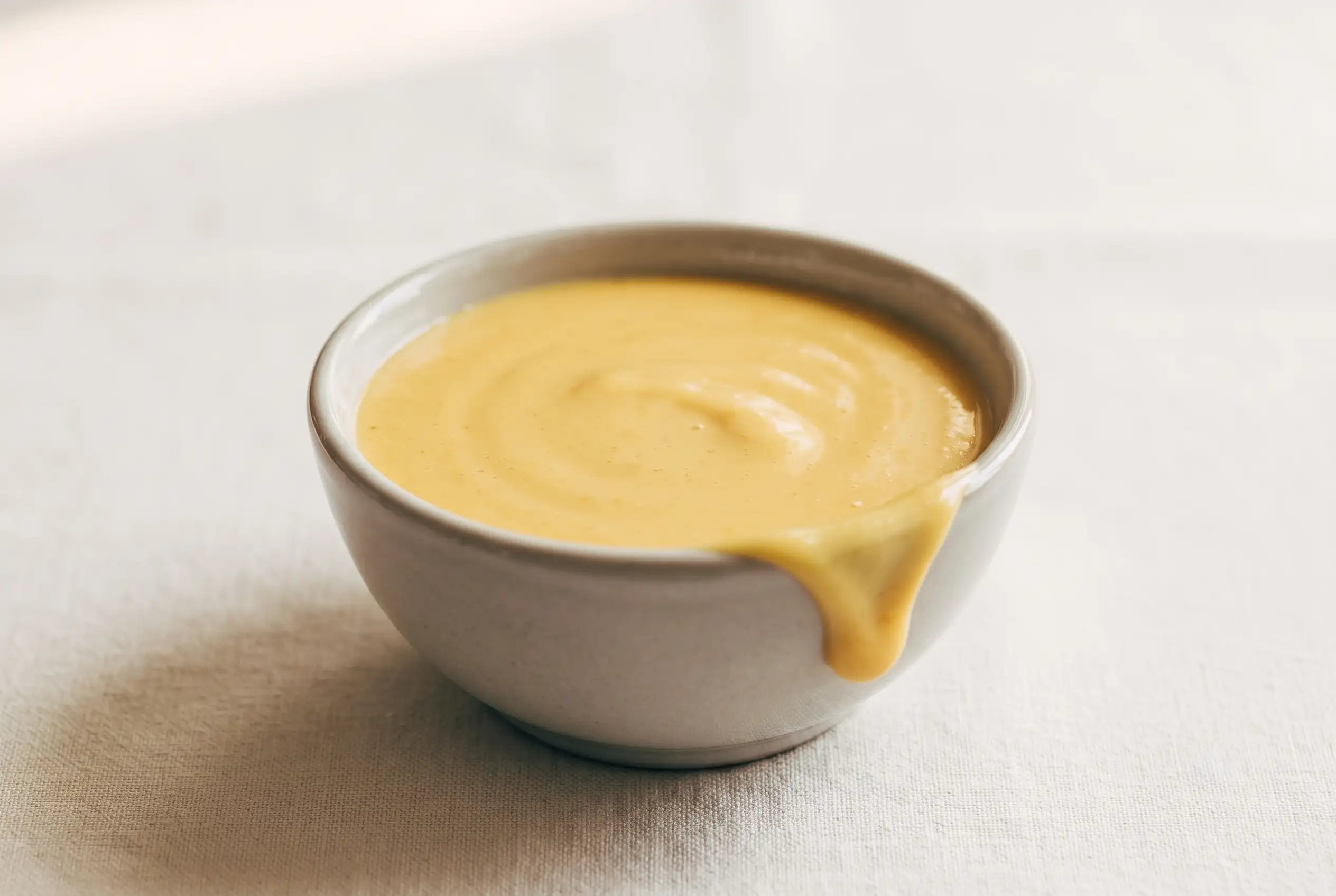 Creamy honey mustard sauce with Dijon mustard and mayonnaise in a small dipping bowl